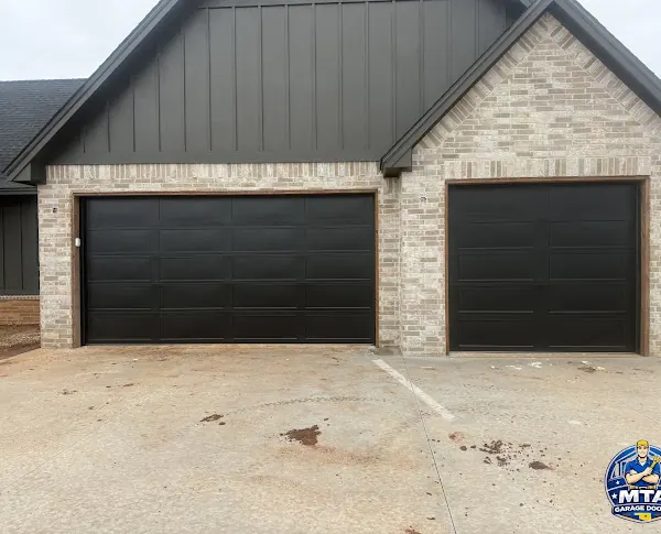 Black residential garage doors photographed for MTA Garage Doors