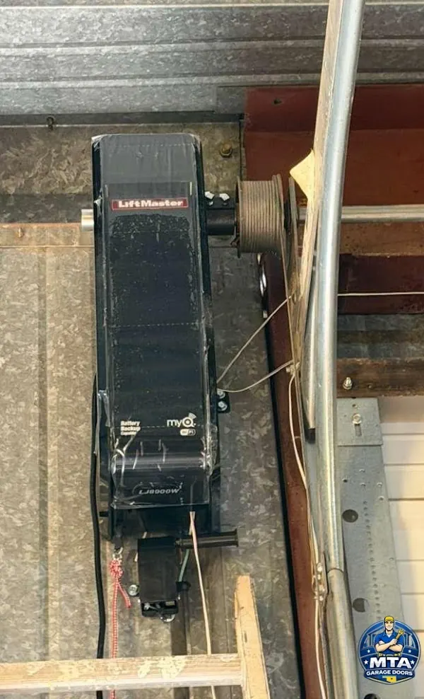 Close view of residential garage door opener controls and wiring