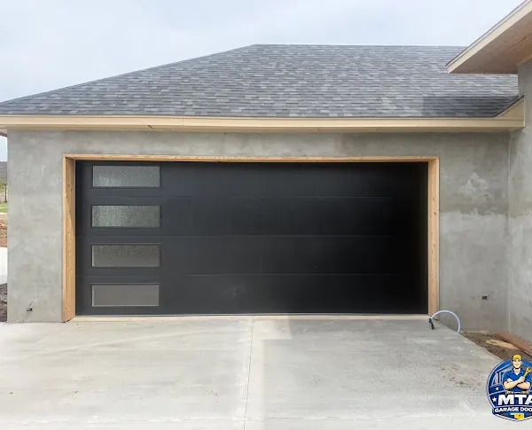Black residential garage door photographed for MTA Garage Doors