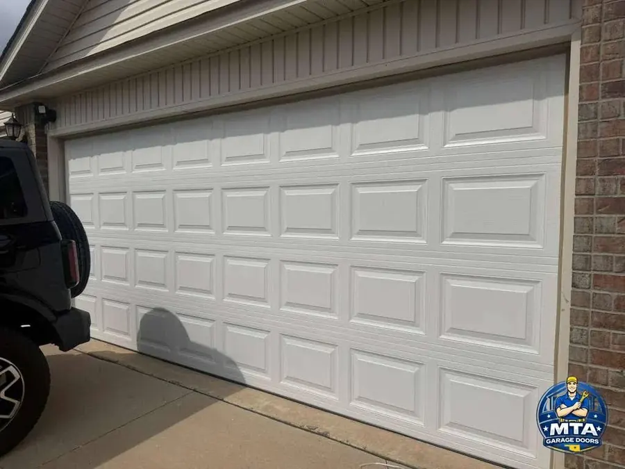 Exterior view of a white sectional residential garage door photographed for MTA Garage Doors